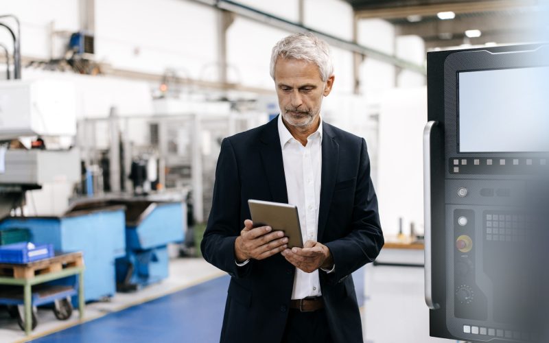 manager using digital tablet in high tech company.jpg